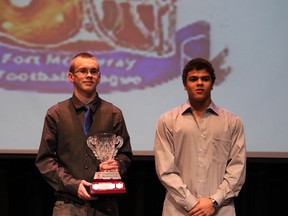 Westwood Jr Trojans player Tyler Henderson presents Westwood Trojans Nathan Mayers with the Fort McMurray Football highschool League MVP at the Fort McMurray Football banquet Sunday at Keyano theatre. SUPPLIED PHOTO