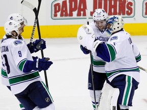 Vancouver Canucks' Alexander Edler (2nd R), Roberto Luongo (R), Zack Kassian (9) and Dan Hamhuis celebrate after their 2-1 shootout victory over the Columbus Blue Jackets in their NHL hockey game in Columbus, Ohio March 12, 2013.  (REUTERS)