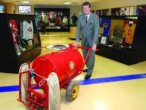 Mark Potter, president of the International Hockey Hall of Fame, moves an ice hand flooder, which was used by the City at the Harold Harvey Arena in the 60s. The historic piece is one of hundreds on display at the new temporary home of the museum, which is located on the second floor of the INVISTA Centre.     Rob Mooy-Kingston This Week