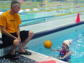 Dave Hill, coach of the Queen’s University Varsity men and women’s polo teams, speaks with Emily Ready, a player and lead instructor of the I Love Water Polo youth program, which is offered through Queen’s University.     Justin Smith-Kingston This Week
