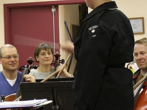 Ordinary Seaman Barstad of Royal Canadian Sea Cadet Corps Tiger directs the musicians of the Timmins Symphony Orchestra during rehearsal. Members of the cadet corps’ band visited a TSO practice session to gain insight into opportunities the study of music can offer them in the future.