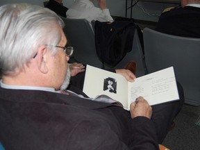 Tillsonburg resident Larry Scanlan, signs the book of condolences for Canadian icon Stompin Tom Connors. The Town of Tillsonburg paid tribute to the much loved musician and entertainer at Monday nights council meeting. Tillsonburg residents will have the opportunity to sign the book of condolences, share a memory or their favourite Stompin Tom song, at the customer service desk in the Tillsonburg Community Centre, where the book will reside over the next week. The book will then be given to the Connors family on behalf of the Town of Tillsonburg. 

KRISTINE JEAN/TILLSONBURG NEWS/QMI AGENCY