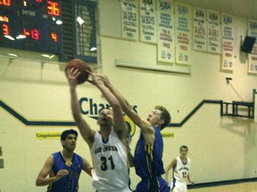 Bert Church Charger Will Bolcsfoldy grabs a rebound in front of a Brooks Buffalos defender during the Chargers’ 81-73 victory in the 4A South Central Zone senior boys’ basketball playoffs at Bert Church on Saturday night.

CHRIS SIMNETT/AIRDRIE ECHO