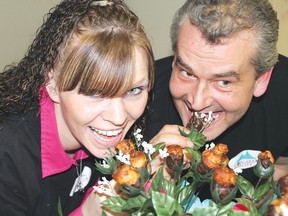 Raquel Morley and Corey Tucker take a bite out of their chocolate covered bacon shaped roses. Their business, Cupcakes in the City (Sault Ste. Marie) took home top prize in the professional chocolatier category during the Choco L’Art event held on Friday at the Moose Family Centre in Elliot Lake.
Photo by JORDAN ALLARD/THE STANDARD/QMI AGENCY