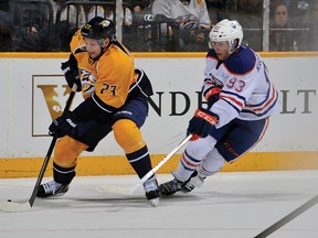 Airdrie’s Zach Boychuk, a forward for the Nashville Predators, controls the puck in front of Edmonton Oilers forward Ryan Nugent-Hopkins during Nashville’s 6-0 victory on Mar. 8. Boychuk was picked up by the Predators off waivers on Mar. 7 and scored his first goal of the season against the Oilers. 
FREDERICK BREEDON/GETTY IMAGES/AFP