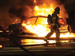 An Airdrie fire fighter walks past a burning car during a massive blaze in Big Springs in 2010. The Airdrie Fire Department recently took their Fire Master Plan to city council last week. 

JAMES EMERY/AIRDRIE ECHO FILE PHOTO