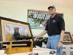 Martin Hartig of the Boss Gobblers of Brant/Oxford, a chapter of the National Wild Turkey Federation, shows of some of the auction and raffle items available at the Boss Gobbler's Hunting Heritage Super Fund dinner on Friday, March 8, 2013. MICHAEL PEELING/The Paris Star/QMI Agency
