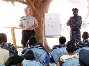 Rob Andrews is training Sudanese officers how to search vehicles for improvised explosive devices (IEDs) under the shade of a mango tree. Photo supplied.