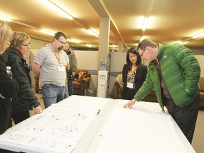 Members of public and Genivar staff examine the designs for the second phase of the Main Street Revitalization project at a recent open house March 4.