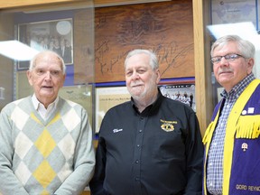 The Tillsonburg Lions still have the stompin' board used by Stompin' Tom Connors in Tillsnoburg during a July 1990 show, autographed by Connors "from a friend, always." From left are Tillsonburg Lions' Jack Whitmore, Vern Fleming and Gord Reynolds. CHRIS ABBOTT/TILLSONBURG NEWS