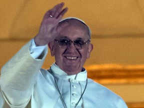 AFP PHOTO / VINCENZO PINTO 
Argentina’s Jorge Bergoglio, elected Pope Francis I waves from the window of St Peter’s Basilica’s balcony after being elected the 266th pope of the Roman Catholic Church on March 13, 2013 at the Vatican.