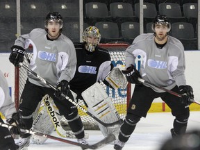Kingston Frontenacs forwards Sam Schutt, left, and Cody Alcock position themselves in front of goalie Mike Morrison at practice at the K-Rock Centre on Wednesday. (Ian MacAlpine/The Whig-Standard)