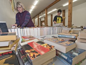 Cynthia Harding and Dakota St. Pierre price and sort books in preparation for the annual Brantford Symphony Orchestra Book Fair. The popular sale will be held April 24-27, this year located in the former Pleasant Ridge Saddle Shop building at 653 Colborne Street West in Brantford. (BRIAN THOMPSON The Expositor)