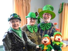 Pictured with a couple of leprechauns and in their festive attire are (left to right) Lillian Harron, Margitta Lange and John Dallaire as their wait for their St. Patrick's Day luncheon dessert.