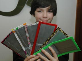 Central Elgin Collegiate Institute Grade 9 student Calvin Huybers with a few Simple Fortunes-brand duct tape wallets. Huybers and a few classmates started the business through the Junior Achievement program and have sold over 100 since last fall.
