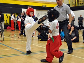 Colby Wallace from the Sapay Martial Arts School throws a side kick in a point sparring match at the Sikaran Open Martial Arts Tournament, March 9, in Winnipeg.