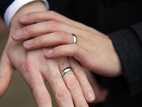 A couple show their rings after getting married outside Seattle City Hall in Seattle, Washington December 9, 2012. (Reuters/Cliff Despeaux)