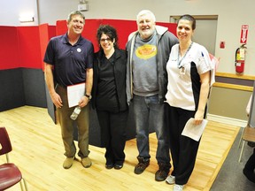 Canadian Blood Services phlebotomists Rhonda Coughlar, second from left, and Janice Willson, right, join Dale Robinson, left, and Ted Anderson after Robinson and Anderson gave blood for the 75th and 100th time, respectively, at Tuesday's blood donor clinic at the Germania Hall in Pembroke.