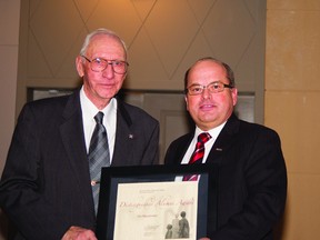 Above left, Ian MacDonald accepts his Distinguished Alumni Award from college president Don Gnatiuk at the President’s Award Luncheon March 5 at GPRC in Grande Prairie.