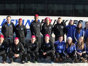 The Keyano College Huskies futsal teams pose for a photo in front of their team bus Thursday before heading down to Olds for the ACAC provincial championships. Most of the men’s team dyed their hair pink in support of Hair Massacure, a campaign that helps children with life-threatening illnesses. Note: absent from the photo is Huskies goaltender Lisa Harrison.  TREVOR HOWLETT/TODAY STAFF