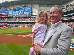 Houston Astros owner Jim Crane and granddaughter Emma Thompson are seen on the field before the Astros play against the Colorado Rockies on opening day of the MLB National League season in Houston April 6, 2012. (REUTERS/Richard Carson)