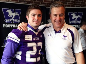 St. Mary's High School student Avery Reyner, with Western University Mustangs head coach Greg Marshall, was one of 34 new recruits announced for the Mustangs football program March 6 in London. As one of the top football programs in Canada, Reyner - a defensive back from Drumbo - was one of seven defensive backs introduced and will start at Western this fall after experience in both high school and club football. (Submitted photo)