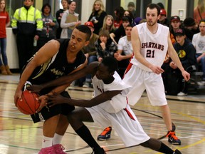 Composite High School Miners guard Khalid Osman protects the basketball against defenders from the St. Peter the Apostle Spartans in game one of the ASAA high school basketball provincials from Spruce Grove. Gord Montgomery/Supplied Photo