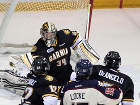 Sarnia Sting goalie J.P. Anderson makes a glove save against the Saginaw Spirit Thursday, March 14, 2013 at the RBC Centre in Sarnia, Ont. PAUL OWEN/THE OBSERVER/QMI AGENCY