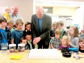 Pastor Anderson cutting the cake with some excited onlookers as Shoreline Baptist Church was officially introduced on March 10.