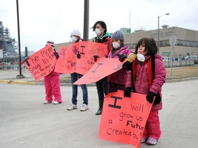 Protesters rally outside Sarnia's Imperial Oil facility Friday. More than 100 hundred protesters made their way through the Chemical Valley Friday afternoon, calling for more accountability for industrial pollution. BLAIR TATE / SPECIAL TO THE OBSERVER / QMI AGENCY