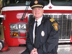 Deputy Chief Dana Pitts officially retired Friday from the Sarnia Fire Rescue Service after more than 35 years. Pitts poses on the fire truck he was set to take the traditional ride home given to firefighters on their last day on duty. Sarnia, Ont., March 15, 2013  (PAUL MORDEN, The Observer)