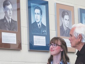 Hannah Beckett and Dan Coates look at portraits of the Brantford men who served in the First World War after attending Brantford Collegiate Institute. Hannah's great, great uncle Lieutenant Arlington Austin Beckett died in the war at the tender age of 20. (VINCENT BALL The Expositor)