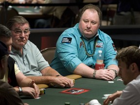 Poker professional Greg Raymer (C) of the U.S. competes on the first day of the 41st annual World Series of Poker no-limit Texas Hold 'em main event at the Rio hotel-casino in Las Vegas, Nevada July 5, 2010. It is expected that 6,000 to 7,000 players will pay the $10,000 buy-in to enter the tournament, officials said.  Raymer won the main event in 2004. (REUTERS/Las Vegas Sun/Steve Marcus)