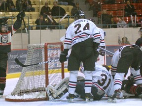 Brantford Blast captain Chad Spurr (left) celebrates while Corey Stringer is at the bottom of a pile after scoring on Dundas Real McCoys goalie Brock Novak Friday in Game 3 of the best-of-seven Allan Cup Hockey final series. (DARRYL G. SMART The Expositor)