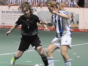 Wolves player Payton Esau (6) and Calgary's Rae Ann Rigal battle for ball possession during the first half of the round robin game between the Grande Prairie Wolves and CNS Titanium of Calgary on Friday, March 15, 2013. The Wolves are hosting the U16 Tier 2 Alberta Soccer Indoor Provincials in Grande Prairie, Alberta, March 15-17, 2013.   TERRY FARRELL/DAILY HERALD-TRIBUNE/QMI AGENCY