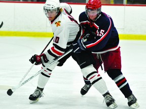 Brockville Braves captain Chris Roll (10) battles with Cornwall Colts forward Marly Quince on Friday night at the Memorial Centre during game three of the CCHL Jr. A playoff series between the two teams. (STEVE PETTIBONE The Recorder and Times)