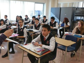 Students and their teacher crunch the numbers during math class at St. Patrick Secondary Catholic School on Felstead Ave. (DAVE THOMAS/Toronto Sun)