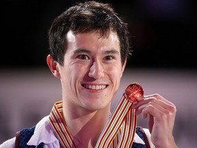 Canadian skater  Patrick Chan holds up his gold medal after winning the Mens Free Skate along  at the World Figure Skating Championships in London, Ontario on Friday, March 15, 2013. (DEREK RUTTAN/QMI AGENCY)