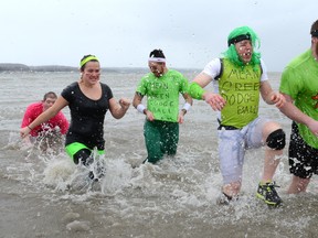 Participants in the 14th Annual Polar Bear Dip for Special Olympics run out of the bay Saturday afternoon after dunking themselves in Owen Sound Bay. Sun Times Photo/QMI Agency/James Masters.