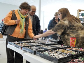 Natalie and Dean Verwey check out some sterling silver and stainless steel rings at Brenda Haddad's booth at the Herman Prior 55-plus Centre's annual spring craft sale Saturday. Haddad promotes her handcrafted and imported jewelry under the business name Brenda's Bling.  (CLARISE KLASSEN/PORTAGE DAILY GRAPHIC/QMI AGENCY)