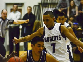 Nikko Guce (left) from Edmonton's St.Francis Xavier Rams runs past Danny Henry (right) from Calgary's Bishop O'Byrne Rams at Bishop Grandin High School on March 15, 2013. The Rams defeated the Bobcats 71-56 in quarter final action at the 2013 ASAA High School Basketball Provincials.  Gavin John/STR/QMI Agency