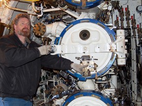 Dean Lewis, former Ojibwa submariner and restoration technician with Project Ojibwa, demonstrates how a torpedo was loaded into a tube onboard the submarine. Media were given a first glimpse inside the sub, Friday in Port Burwell.