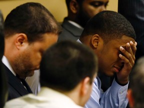 Ma'lik Richmond (R) reacts as the verdict is read in the juvenile court in Steubenville, Ohio March 17, 2013.  REUTERS/Keith Srakocic/Pool