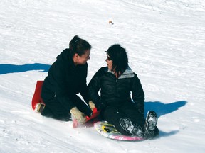 Sliding isn’t just for children as Marilyn Sewell, left and Lana Henton-Sullivan prove. The two women took their children sliding Wednesday and joined in on the fun.
GRACE PROTOPAPAS/Daily Miner and News
