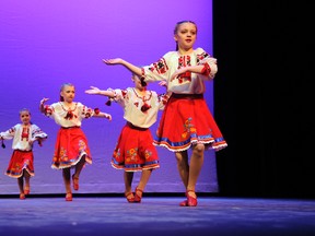 Junior dancers Emma Glover, Ava Wolff, and Victoria Duchek perform a traditional Ukrainian dance Saturday at Grande Prairie Regional College as a part of the Vitaemo Festival hosted over the weekend. The annual festival, which is hosted by the local Troyanda Ukrainian Dancers group, celebrated its 10th anniversary. The festival featured several dance groups from all over the province as well as arts and crafts, traditional Ukrainian food and a marketplace. (Adam Jackson/Daily Herald-Tribune)