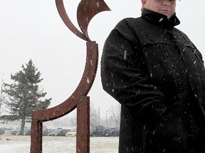 Artist Noel Bullock with his metal giraffe.  (Paul Schliesmann The Whig-Standard)