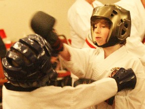 Caleb Leblond, right, connects during the sparring segment of the North Bay Invitational Martial Arts Tournament, Saturday, at Clarion Resort Pinewood Park.