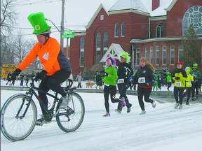 Wearing an oversized leprechaun hat, race volunteer Paul Lovelock  leads the second annual Shamrock Shuffle on Saturday in St. Thomas. The early-season race which benefits Inn Out of the Cold at Central United Church, raised over $17,000. Eric Bunnell/QMI Agency/Times-Journal