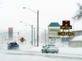 Cars travel along Saskatchewan Ave. during a snow storm, Monday. Drivers are being advised to drive with caution and drive for the weather as many roads across the province are snow and ice covered. (ROBIN DUDGEON/PORTAGE DAILY GRAPHIC/QMI AGENCY)