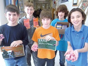 St. Aloysius Catholic School pupils, front row, from left, Ryan Adair, Joey Cassone and Luke McCarroll and, back row, from left, Mackenzie Campbell and Haydn Shantz have collected more than 730 erasers to make an important point during their Erase Bullying initiative in Stratford. (SCOTT WISHART The Beacon Herald)